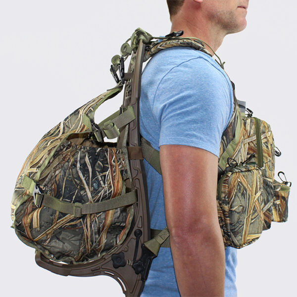 Man wearing camouflage chest pack and backpack with white background